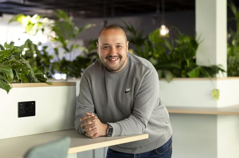 Dave Ferry, Chief Sales Officer at ITS, smiling in a modern office environment with indoor plants