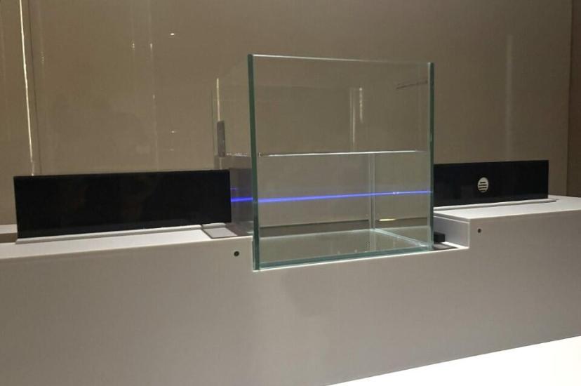 UWOC demonstration showing a blue laser beam traversing a glass tank of water