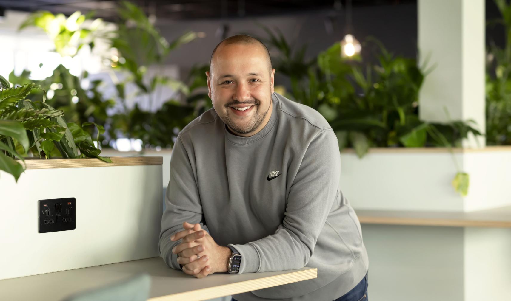 Dave Ferry, Chief Sales Officer at ITS, smiling in a modern office environment with indoor plants