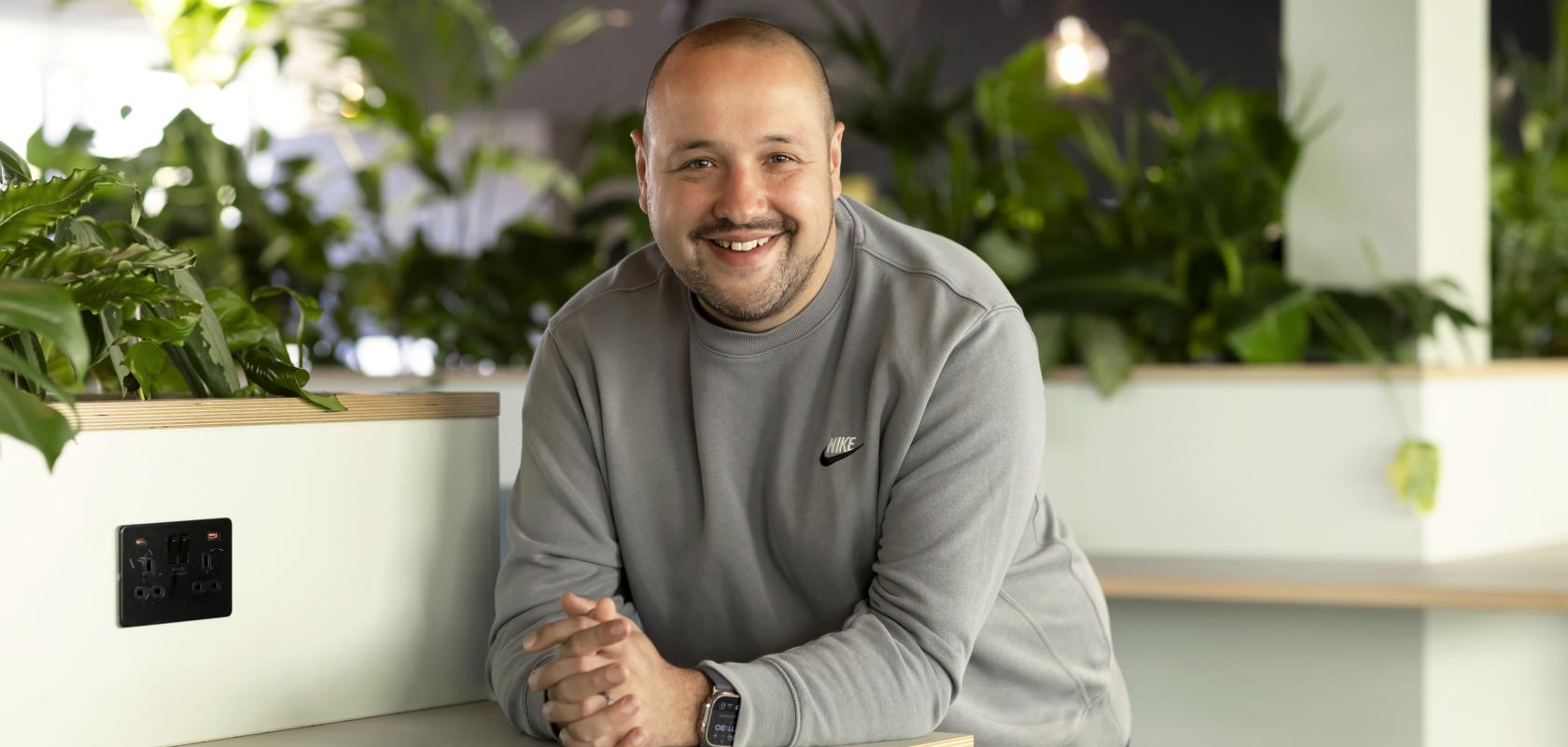 Dave Ferry, Chief Sales Officer at ITS, smiling in a modern office environment with indoor plants