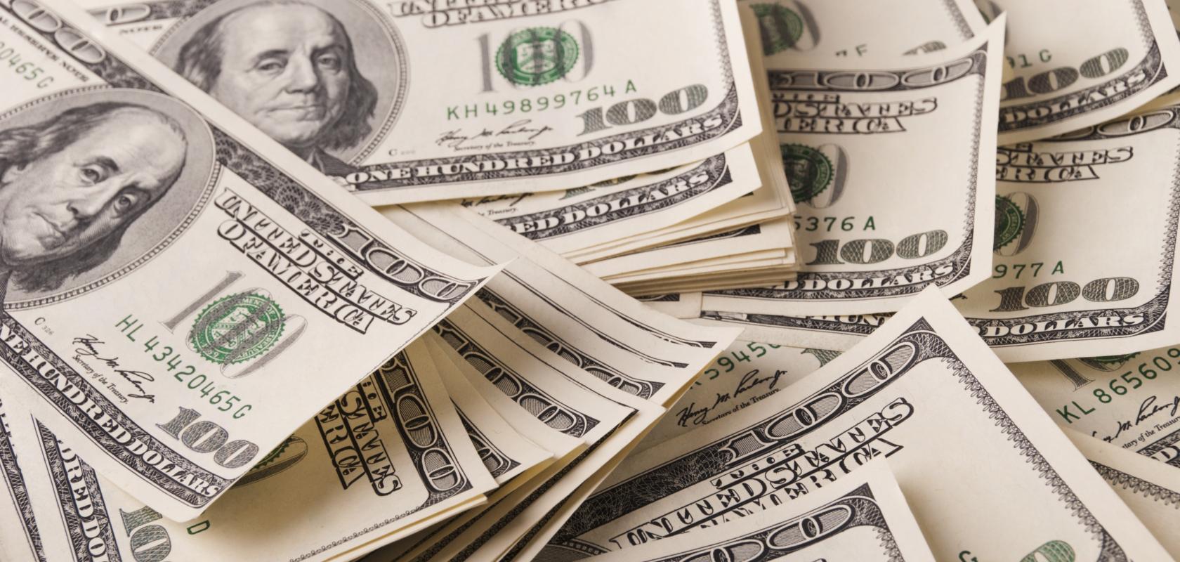 Large pile of US dollar bills