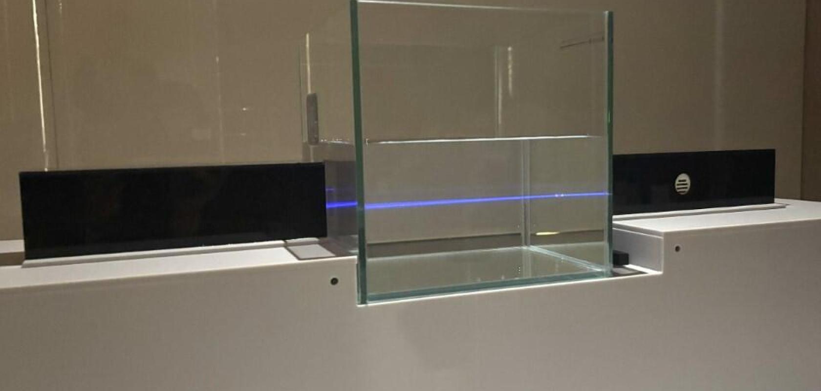 UWOC demonstration showing a blue laser beam traversing a glass tank of water