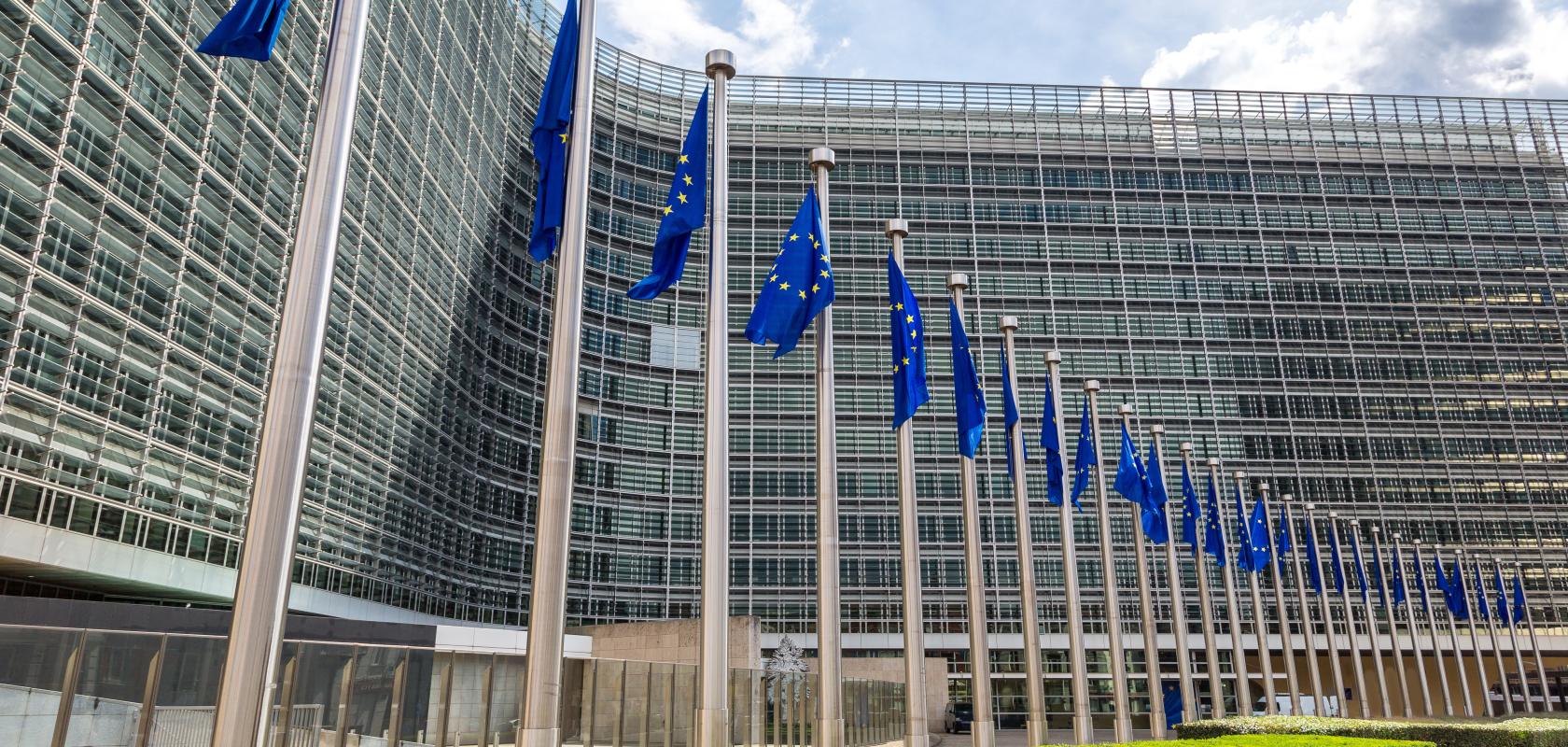European flags in front of headquarters of European commission in Brussels in summer day to illustrate The FTTH Council Europe has endorsed the European Commission's proposed Digital Networks Act (DNA)