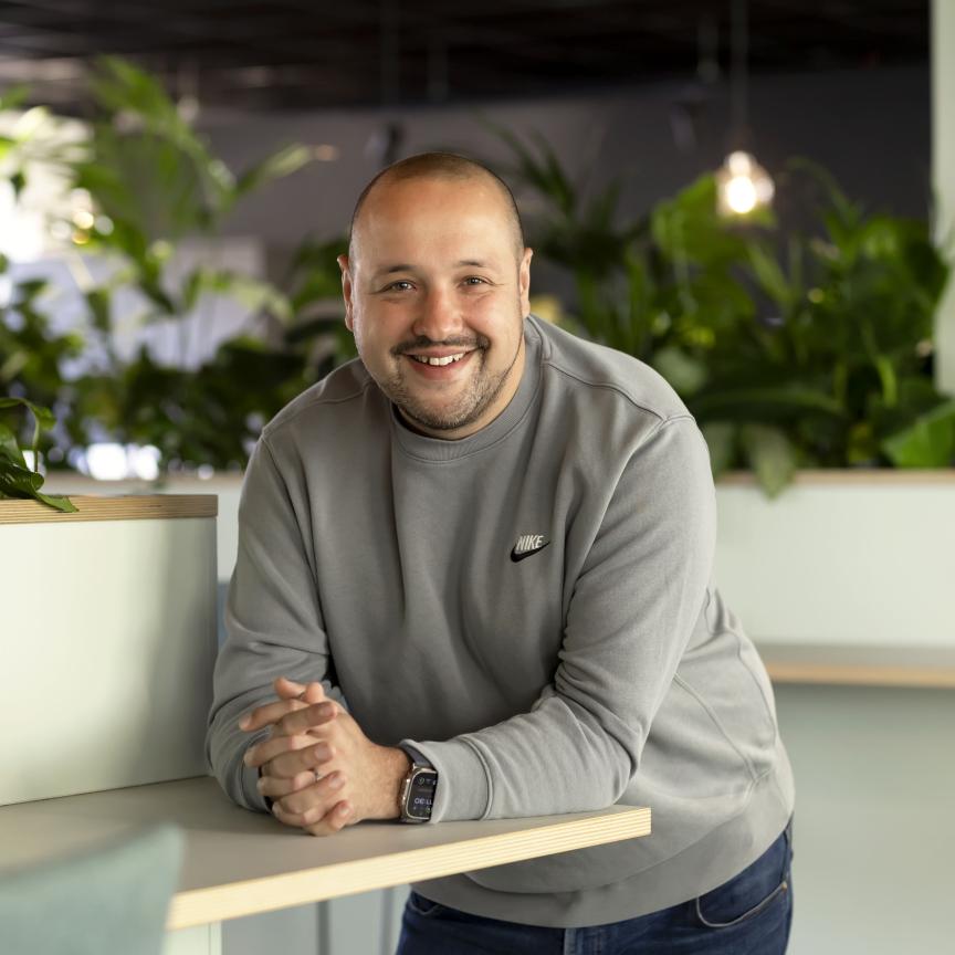 Dave Ferry, Chief Sales Officer at ITS, smiling in a modern office environment with indoor plants